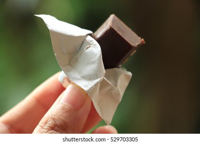 Unwrapping A Piece Of Chocolate