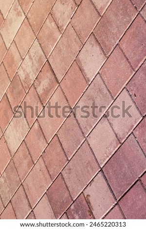 An upclose shot of a diagonal patterned red brick floor, resembling brown brickwork. The rectangular shapes create a unique flooring design
