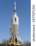 An up-close shot of an old, historic rocket that has been preserved and is standing tall in an outdoor area