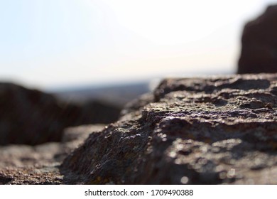 Upclose shot of some rocks over looking a city