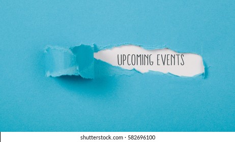 Upcoming Events message on torn blue paper revealing secret behind ripped opening.