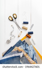 Upcycle Old Denim Garbage. Recycling Blue Jeans Cut Pieces, Sewing And Home Needlework. Recycling And Scissors On White Background. Circular Economy. Zero Waste Banner With Copy Space. DIY Concept