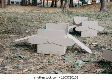 Upcycling Ideas, Recycle Crafts. Toy Airplane Made From Cardboard Boxes On Grass. DIY Creative Cardboard Paper Ideas For Children.