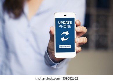 Update phone message in a cellphone screen. Woman holding mobile in the hand. Close up - Shutterstock ID 359082632