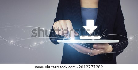 Update Software Computer Program concept. White tablet in businesswoman hand with digital hologram download sign on grey background. Download Internet Connection.