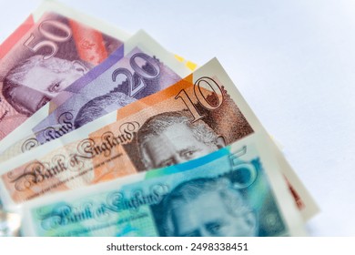 Updated Pound Sterling bank notes with the King's portrait isolated in a white background.