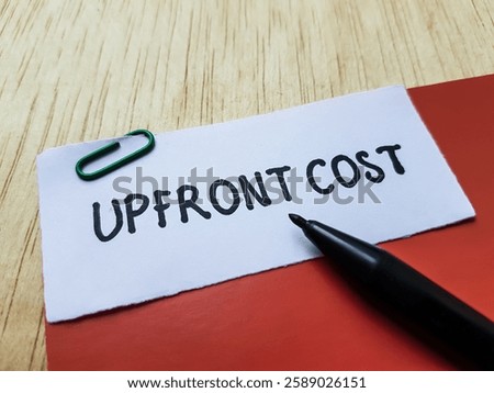 Upfront cost writting on table background.