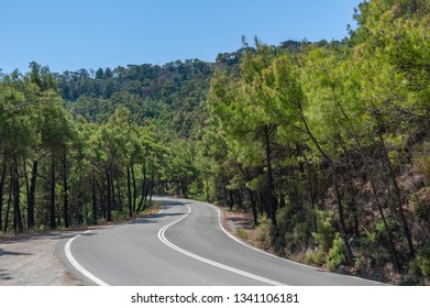 Uphill A Curvy, Bendy Road. Open Road Through Forest On Hillside. Open Road. Empty Road With No Traffic In Countryside. Rural Landscape. Greece.