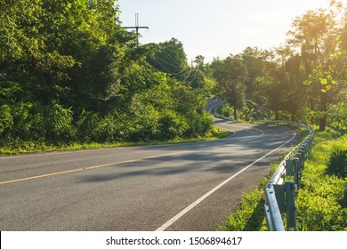 Uphill Road With A Curve With Sunlight