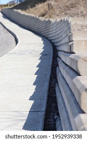 An Uphill Street, The Sidewalk And The Cement Blocks
