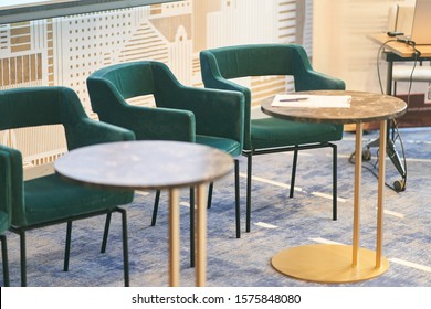 Upholstered chairs and round tables in the conference room.