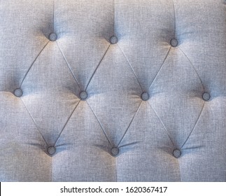Upholstery Fabric sofa backrest with fabric button tufting grey color, Luxury background interior and  furniture design.