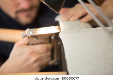 Upholstery Worker Stapling Furniture Cover Padding