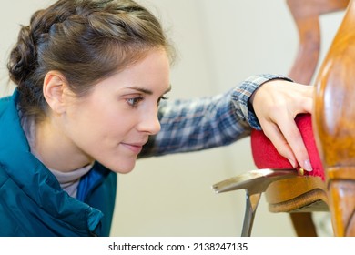 Upholstery Worker Tapping Pin On The Chair