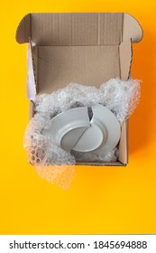 Upon Opening, The Parcel Contained A Broken Plate, Yellow Background