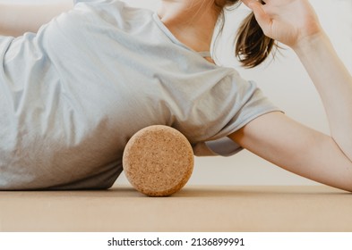 Upper Body Details Of Woman Rolling Lower Armpit On A Cork Massage Roller To Release Tension In Side Body Muscles. Concept: Self Care Practices At Home, Sustainable Props, Myofascial Release