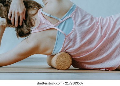 Upper Body Details Of Woman Rolling Lower Armpit On A Cork Massage Roller To Release Tension In Side Body Muscles. Concept: Self Care Practices At Home, Sustainable Props, Myofascial Release