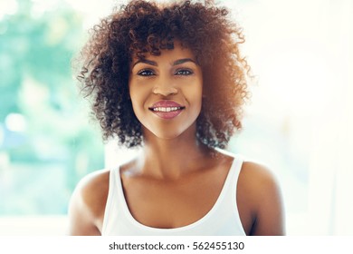 Upper Body Portrait Of Smiling Young Black Woman In Sunshine With Copy Space