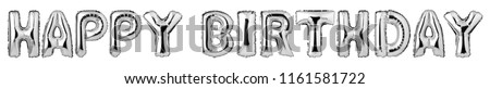 Upper case letters HAPPY BIRTHDAY from silver balloons