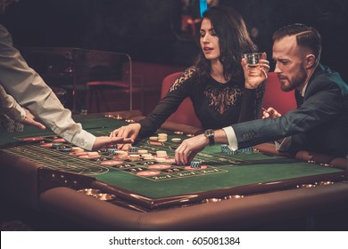 Upper Class Friends Gambling In A Casino.