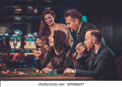 Upper Class Friends Gambling In A Casino.