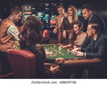 Upper Class Friends Gambling In A Casino