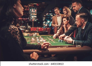 Upper Class Friends Gambling In A Casino