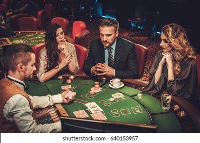 Upper Class Friends Gambling In A Casino