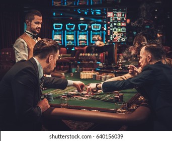 Upper Class Friends Gambling In A Casino