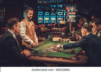 Upper Class Friends Gambling In A Casino