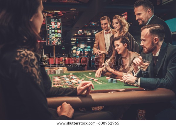 Upper class friends\
gambling in a casino