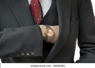 Upper Class Man Reaching In Pocket For Checkbook With Gold Watch