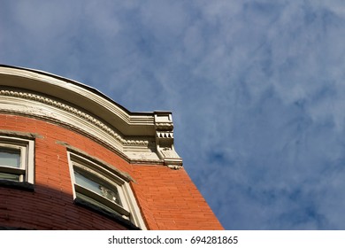 upper corner of a brick building with blue sky