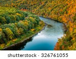 Upper Delaware river bends through a colorful autumn forest, in Hawk