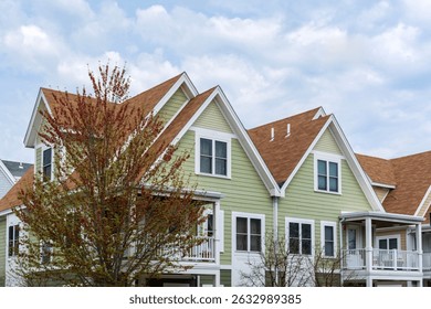 Upper facades of charming multi-unit homes with composite roofing and balconies in Brighton, Boston, Massachusetts, USA
