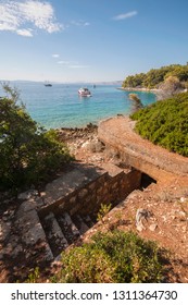 Upper Half - Idyllic Turquoise Blue Beach, Summer, Sea, Vacations Season, But On Down Half - Entrance In The Bunker Used To Guard Island Prvic, Croatia, Female Prison During Communist Era.Authentic.