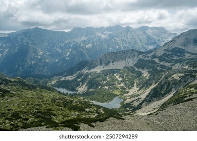 Upper and Lower Vasilashko lake in Pirin Mountains. The mountain lakes are surrounded by spectacular landscape of rocky slopes and high altitude alpine flora. The nature photo was taken in late June. - Powered by Shutterstock