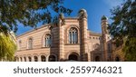 Upper part of main facade of the Dohany Street Synagogue, or Great Synagogue built in 19th-century with two towers with domes at autumn sunny morning, Budapest, Hungary, panoramic view 
