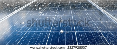 Upper surface of solar rooftop which has been used for a long time is stained with dust, bird droppings, dirt, smog and rainwater stains, concept for cleaning, washing and maintainance, cropped shot.