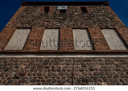 Upper tower section of historic fieldstone church in Lindenberg, Ahrensfelde, Marzahn, Germany