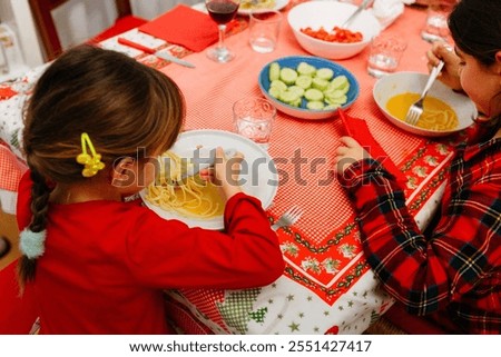 upper view of the children sitting at the table on Christmas eve having dinner together