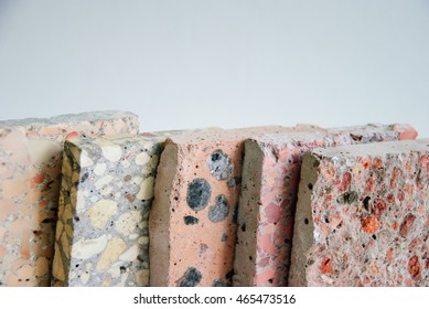 Upper view of concrete slabs, assorted construction materials, with copyspace (on white)