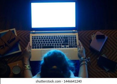 Upper View Of Elegant Woman Sitting On Sofa In The Modern Living Room Looking Blue Light Computer Screen On A Laptop.