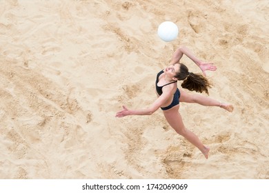 Upper View of Female  Beach Volleyball Player at Service - Powered by Shutterstock