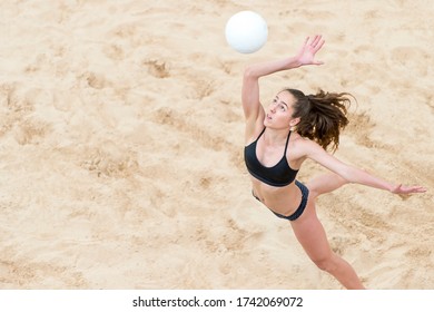 Upper View of Female  Beach Volleyball Player at Service - Powered by Shutterstock