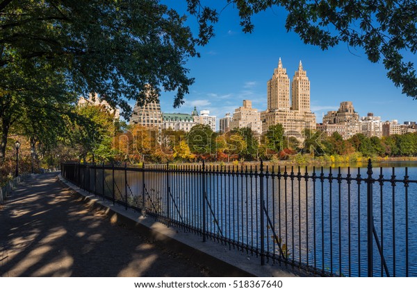 Upper West Side with colorful fall foliage across\
Jacqueline Kennedy Onassis Reservoir. Central Park West. Manhattan,\
New York City