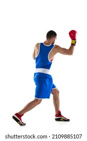Uppercut. Portrait of one professional boxer in blue uniform training isolated over white background. Fighter practicing in action. Health, sport, motion concept. Copy space for ad.