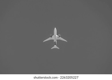 Uprisen angle view of the airplane flying after take off or before landing with black and white toned, Under view of aircraft above in the sky, Air transportation background. - Powered by Shutterstock