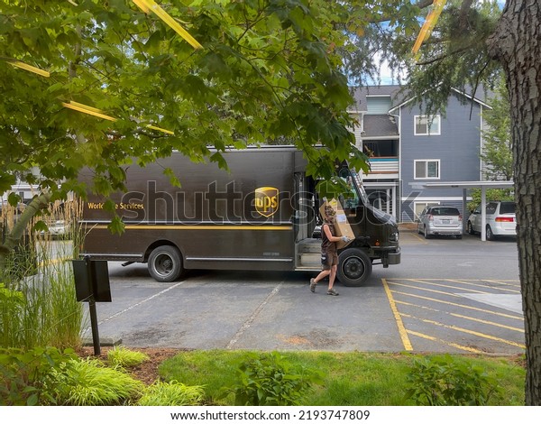 UPS courier carries\
packages from UPS vehicle to delivery point. Everett, WA, USA -\
August 2022