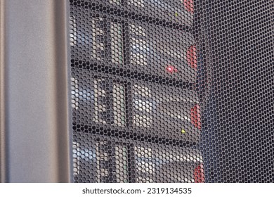 The UPS module in the server room is emitting a red light warning signifying an error with the battery.
